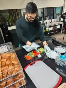 Co Founder of M&M Wealth Associates, Michael Henry preparing food for community event.
