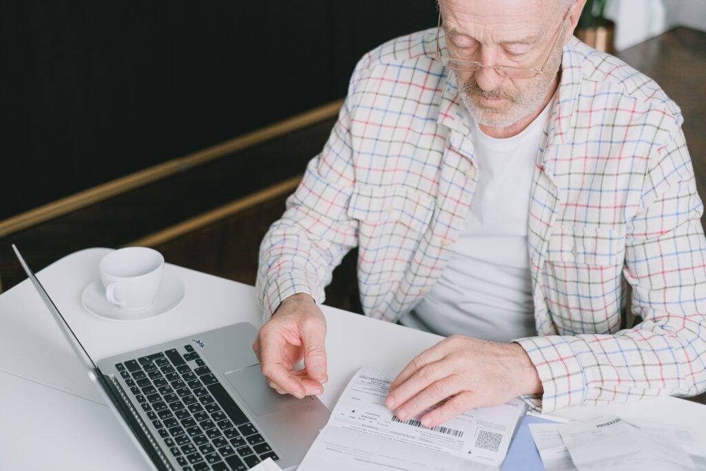 Elder man reviewing finances and taxes.